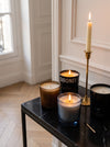Candlelight at MA VIE: Lavune, Sibonei and TEKES candles lit on a black marble console in a white Paris apartment