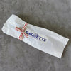 Baguette Four-Wick Candle by BabaBoogs wrapped in its printed paper sleeve, maker photo