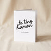 Le Tiny Human letterpress greeting card by Dahlia Press standing on a natural cotton backdrop
