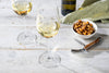 Nori Bar Nuts by Eleven Madison Home on a table set with white wine, maker photo