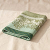Vignoble tea towel folded, showing the hem and the weight of the cloth
