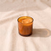 The Field Candle in Bergamot + Amber, moss green glass vessel with two cotton wicks