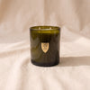 The Field Candle in Orange Blossom + Neroli by House of Good, moss green vessel with a flat unburnt wax surface