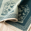 Curiosités Animales jacquard damask folded back to show the same design woven on the reverse in the opposite colourway