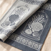 Curiosités Minérales jacquard damask folded back to show the same design woven on the reverse in the opposite colourway