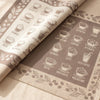 Barista jacquard damask folded back to show the same twelve named coffees woven on the reverse in the opposite colourway