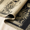 Curiosités Florales jacquard damask folded back to show the same design woven on the reverse in the opposite colourway