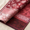 Romance jacquard damask folded back to show the same floral design woven on the reverse in the opposite colourway