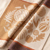 Thanksgiving jacquard damask folded back to show the same harvest wreath woven on the reverse in the opposite colourway