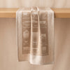 Barista jacquard tea towel draped over an oak edge, showing how the cloth hangs