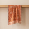 Haute Viennoiserie jacquard tea towel draped over an oak edge, showing how the cloth hangs