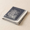 Curiosités Minérales jacquard tea towel folded, showing the weight and thickness of the cloth