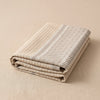 Dune Rayures jacquard tea towel folded, showing the weight and thickness of the cloth