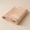Noël au Chalet jacquard tea towel folded, showing the weight and thickness of the cloth