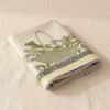 Potager d'Hiver jacquard tea towel folded, showing the weight and thickness of the cloth
