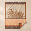 Potager d'Hiver jacquard tea towel by Le Jacquard Français in Potiron, a winter vegetable basket in warm browns and rust, on the MA VIE cotton backdrop