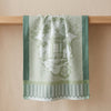 Promenade Impériale in Jade draped over an oak edge, showing how the cloth hangs