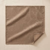 Vegetal Mood jacquard napkin in Bolet laid open on the MA VIE cotton backdrop, the acacia damask read in sheen