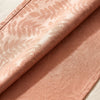 Vegetal Mood napkin in Papaye turned back to show the acacia damask reversing from light to dark on the other face