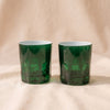 Rialto Old Fashion Glasses in Kale, set of two mouth-blown green glass tumblers by Sir/Madam, on a natural cotton backdrop