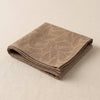 Vegetal Mood napkin in Bolet folded, showing the hem and the weight of the cloth
