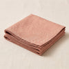 Vegetal Mood napkin in Papaye folded, showing the hem and the weight of the cloth