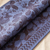 Sulawesi runner in Terre Indigo turned back to show the same foliage woven on the reverse in the opposite colourway