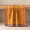 Manor Lane runner draped over an oak edge, showing how the cloth hangs