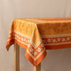 Manor Lane jacquard tablecloth by Le Jacquard Français spread over a plain oak table, showing the fall and the woven border