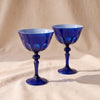 Rialto Coupe Glasses in Midnight, set of two mouth-blown cased glass coupes by Sir/Madam, on a natural cotton backdrop