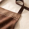 Close detail of the Barista apron bib, the ribbed band and woven coffee bean motif