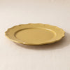 Dijon yellow stoneware dinner plate at a low angle, showing its moulded edge and profile