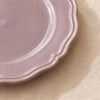 Close detail of the Lavender dessert plate rim, its lobed edge and raised moulding