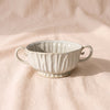 Fluted Centerpiece Bowl by Accent Decor, 14.75 inches wide handle to handle, speckled ivory reactive glaze, footed