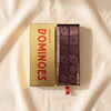 Casa Bosques chocolate domino set, open gold box of six chocolate dominoes, on MA VIE cotton