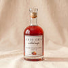 Gris Gris Cocktail Magic blood orange chili simple syrup bottle on MA VIE cotton