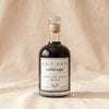 Gris Gris Cocktail Magic rosemary thyme simple syrup bottle on MA VIE cotton