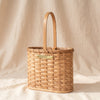 Millstream Home double wine carrier, handwoven reed with bent wood handle and MA VIE brass nameplate, on MA VIE cotton
