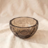 Cut glass bowl in smoky hazel, faceted panels, on natural cotton