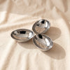 Triple Nut Dish in polished nickel, three egg-shaped hollows in one casting, on natural cotton