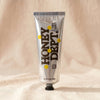 Honey Department Thick Honey 6 oz brushed aluminium tube with black ribbed cap, on MA VIE cotton