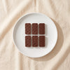 Casa Bosques chocolate dominoes out of the box on a white plate