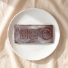 Casa Bosques pure dark Tabasco chocolate bar unwrapped on a white plate