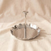 Zodax scalloped serving tray in polished nickel with upstanding petal rim and central handle post, on MA VIE cotton
