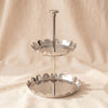 Zodax scalloped two-tier tray in polished nickel with upstanding petal rims, on MA VIE cotton