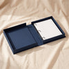Little Miracle photo album by Printworks open, showing the navy tray and white pages on three rings, on MA VIE cotton