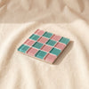 Glass tile coaster in Sour Watermelon, melon pink and teal checkerboard, by Subtle Art Studios