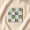 Glass tile coaster in Matcha Milk Chocolate seen from above, by Subtle Art Studios