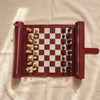 Roll-up travel chess set in burgundy vegan leather, opened and set up, by The Island Society