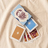 Illustrated playing cards, open tuck box with cards spilling out, by The Island Society